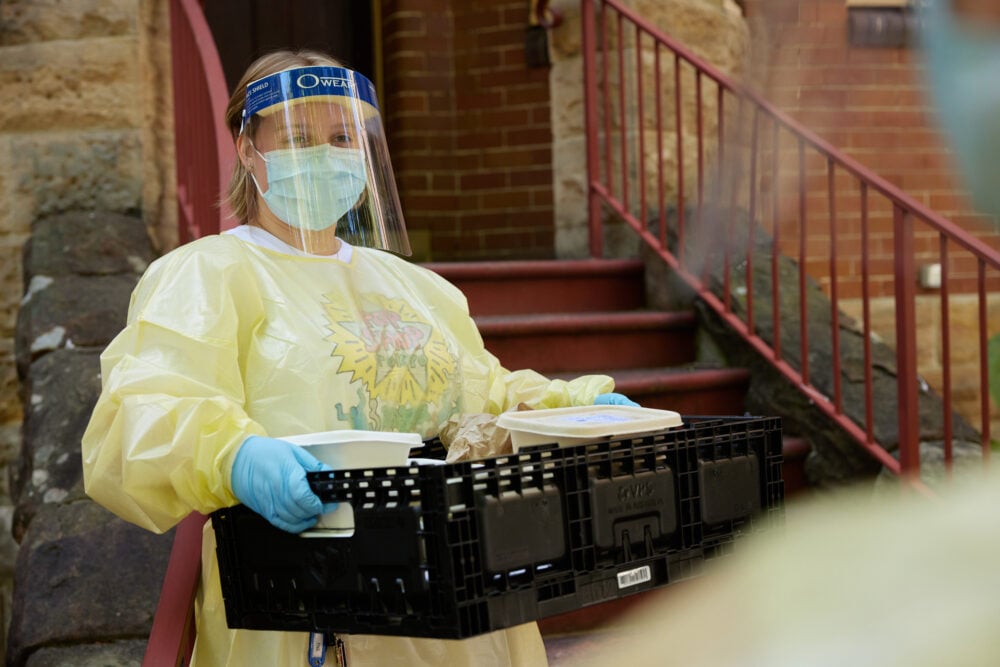 A case worker delivers meals as part of outreach to people experiencing homelessness