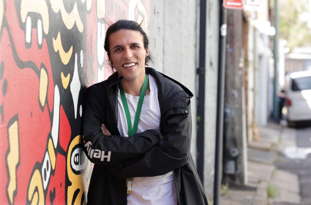 Man leaning against a brick wall